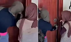 Eve girmeye çalışan hırsızlar kamerayı fark edince binadan kaçtı