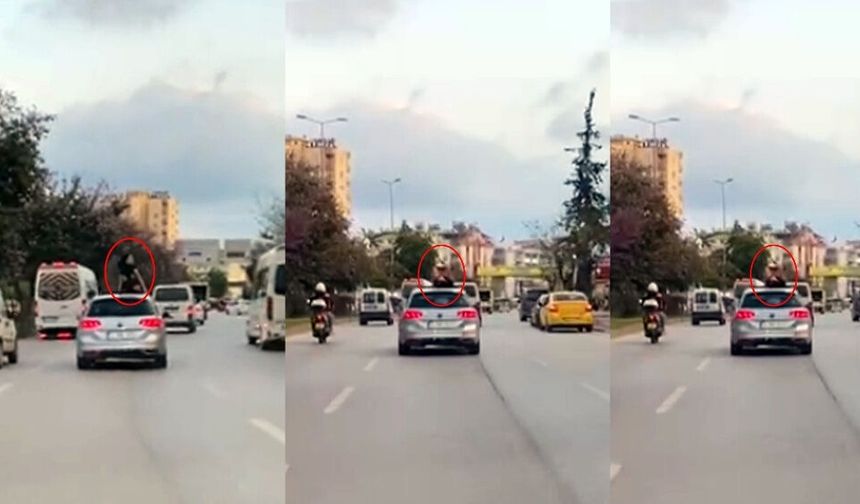 Antalya’da hareket halindeki otomobilde tehlikeli dans kamerada